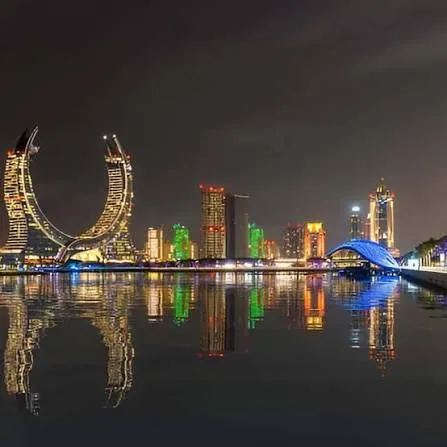 Lusail and Doha skyline lit up at night over the water on a private Doha night tour