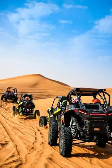 Row of dune buggies lined up in the Qatar desert ready for a guided ride