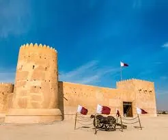 Al Zubarah Fort with Qatari flags on a full-day North and West Qatar tour